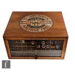 A Dewhurst's Three Shells Sylko machine thread counter top advertising display cabinet, with