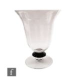 A giant table centre vase, the bell form body above a black glass bladed knop and shallow clear