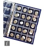 An incomplete Elizabeth II Change Checker album containing two pound coin variants and fifty pences.