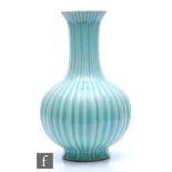 A Chinese Qingbai style bottle vase, the lobed vase with slender neck terminating at a flowerhead