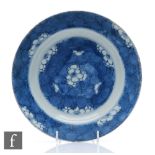 An early 18th Century Chinese blue and white dish of circular form, the cracked ice ground picked