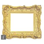 An early 19th Century ornately moulded gilt and gesso picture frame with scrolling acanthus leaf