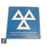 A vehicle testing station enamel sign, 61cm x 64cm.