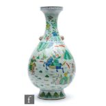 A Chinese famille verte vase, the pear form vase rising from a high spreading footrim, extending