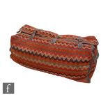 An Oman Bedouin camel woven travel bag, the large woven bag in vibrant orange, white and umber