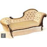 A Victorian chaise longue with exposed foliate carved walnut frame, raised to front cabriole legs,