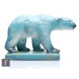 A mid 20th Century model of a polar bear glazed in an ice blue with yellow tints to the