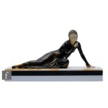 A late 20th Century Art Deco style bronze reclining female figure, with celluloid head and hands,