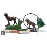 A 20th Century green painted spelter study modelled as a recumbent Alsatian, mounted to a