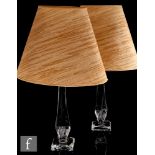 A pair of later 20th Century clear crystal table lamps by Daum, the cushion form square base