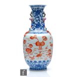 A Chinese blue and white porcelain vase of bottle form applied with iron-red enamels to the