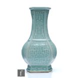 A Chinese celadon glazed vase of facetted hexagonal form, the bottle form body incised with