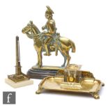 A late 19th Century brass door stop modelled as a cavalry officer on horseback on a stepped iron