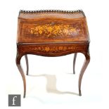 A late 19th Century Louis XV style marquetry inlaid bureau decorated with sprays of flowers and