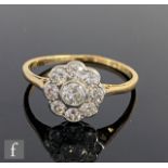 A mid 20th Century 18ct diamond daisy cluster ring, collar set old cut stones, central stone