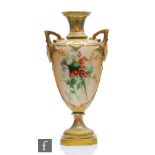 A Royal Worcester shape 1732 pedestal vase decorated with thistles and flowers against a blush