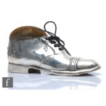 A hallmarked silver pin cushion modelled as a shoe with wooden sole, length 12.5cm, weight 186g,