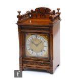 A late 19th Century oak mantle clock with eight day movement striking on a gong, stamped W&E Soh,