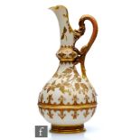 A large late 19th Century Royal Worcester Aesthetic pedestal jug decorated with gilt berries, vines,