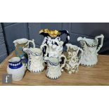 An early to mid 20th Century Bacchanalian jug decorated with relief figures against a blue ground,