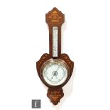 An Edwardian inlaid mahogany aneroid barometer, circular dial below a mounted thermometer, height