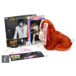 A 1972 Elvis gift bag, including a plush stuffed Hound Dog, a Las Vegas Hilton Summer Festival menu,