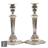 A pair of 19th Century Adam style plated candlesticks, swag decoration on tapering columns and