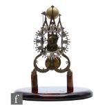 A late 19th Century brass cathedral skeleton clock, single fusee movement striking on a bell,