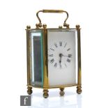 An early 20th Century French brass carriage clock, glass and pillared sides, height 11cm.