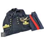 A Marine Corps naval uniform, blue cloth and red stripe to trousers, brass buttons, size unknown,