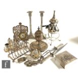 A parcel lot of assorted silver plated items to include a pair of candlesticks, a toast rack,