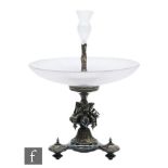 A large 19th Century silver plated centrepiece, the revolving glass ribbed dish over three crossed