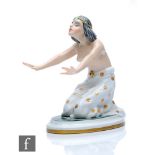 An Art Deco Rosenthal model of a scantily clad kneeling female with her arms outstretched, draped in