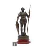 An early 20th Century bronze figure of a medieval French soldier, possibly Joan of Arc, holding a