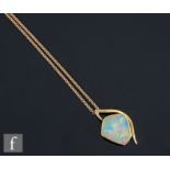 An 18ct irregular cut opal pendant, collar set stones, length 12mm, suspended from an 18ct fine