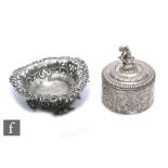 A small Dutch silver circular box and cover terminating in cherub finial, with a small heart