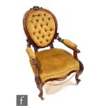 A Victorian serpentine fronted salon open armchair with carved foliate and scroll detail to the