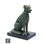 An Art Deco 1930s green painted spelter figure of a sitting Borzoi dog mounted on a black slate