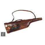 An early 20th Century stitched brown leather leg of mutton shot gun case, with shoulder strap and