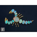 A modern 9ct opal brooch modelled as a scorpion, with fourteen individually claw set stones,