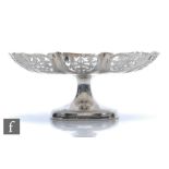 A hallmarked silver pedestal comport, circular base below plain bowl with pierced waved border,