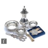 A small parcel lot of assorted hallmarked silver items to include grape scissors, sugar castor,