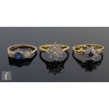 Three 18ct stone set rings, two sapphire and diamond examples and a diamond cluster ring, total