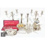 A parcel lot of assorted silver plated items to include a pair of candlesticks, a pair of three