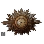An Art Deco period 'Sunburst' wall clock, radiating Swiss dial, height 31cm, width 48cm.