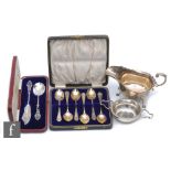 Four items of hallmarked silver to include a cased set of six teaspoons, a sauce boat, a tea