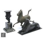 A 19th Century bronze sphinx, width 20cm, a bronze stand modelled as face and collar on green