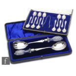 A cased set of hallmarked silver salad servers terminating in cut glass handles, with a cased set of