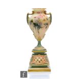A Royal Worcester shape 1942 pedestal vase, the twin handled vase decorated with thistles and