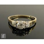 A 9ct hallmarked diamond three stone ring, central brilliant cut stones, approximately 0.65ct,